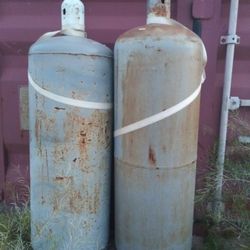 One tall propane tank with 25 - 50% propane inside.