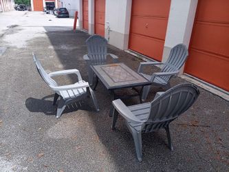 4 plastic chairs and coffee table