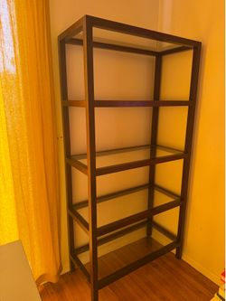 Large brown bookshelf with glass shelves