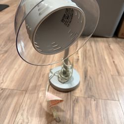 Silver Desk Lamp with Adjustable Neck Sleek silver desk lamp with an adjustable neck. Perfect for reading or workspaces.