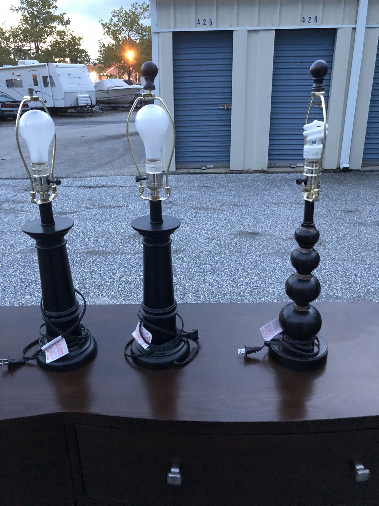 3 lamps with round shades.