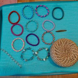 Woven Jewelry Basket With 13 Bracelets and a Pin.