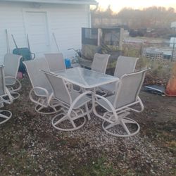 Rectangle patio furniture with six chairs, beige and color swivel rockers hundred and twenty five dollars