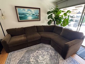 Large brown sectional couch with matching throw pillows