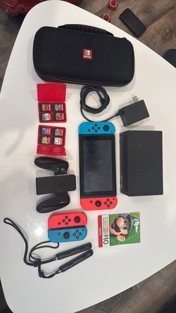 Nintendo Switch- charger,case 4 Joy-Cons, dock/charger, grip, wheels/straps, case, 8 physical games, and accessories and gift card