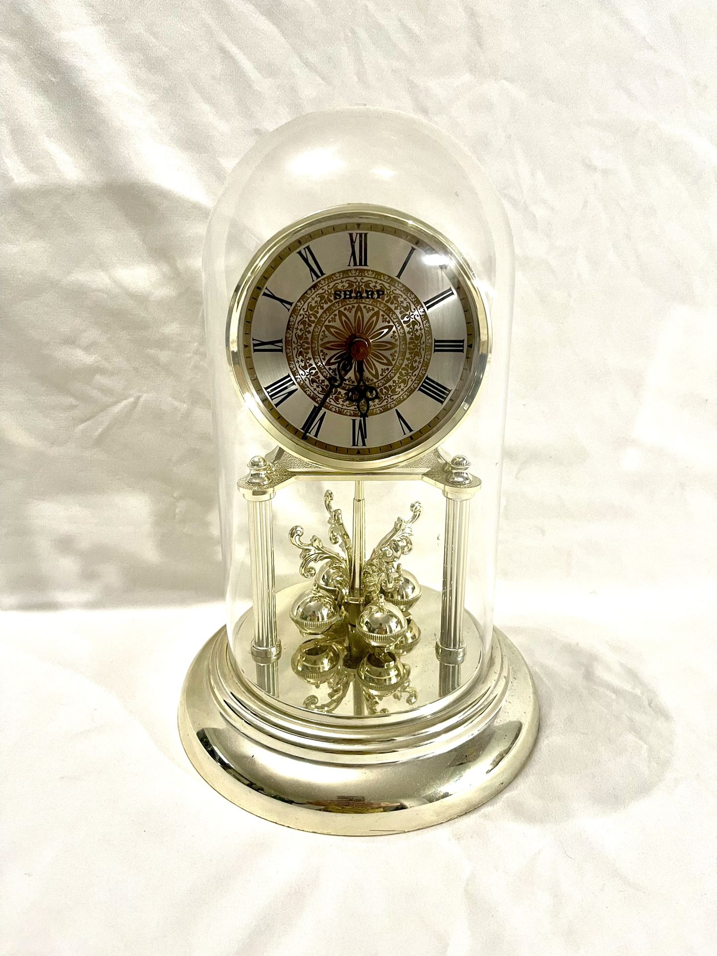 Vintage (Sharp) swinging pendulum clock with 12 inch tall plastic dome