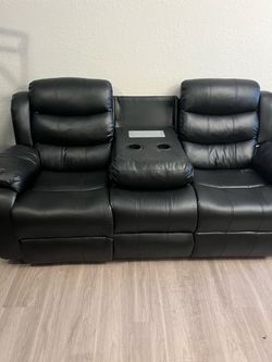 Black leather recliner with outlets for charging phone