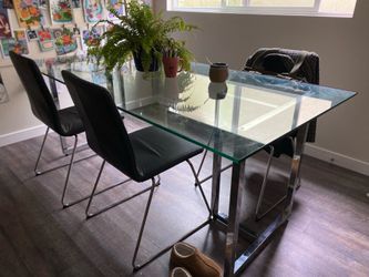 6ft x 3ft glass and metal dining table with 4 faux leather and metal chairs