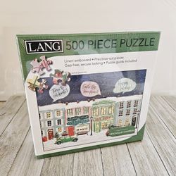 500 Piece Christmas Town Themed Jigsaw Puzzle Featuring art from
Veronique Charron. Linen-embossed, Precision-cut pieces, Gap-free, secure locking, Pu