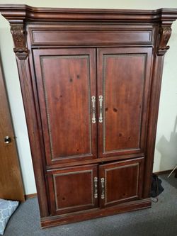 Large Wood Armoire style Entertainment center with Carved Details