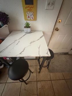 Small high table with two bar stools