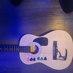 Acoustic Guitar With Picks And Capo 