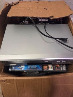 Dvd/vhs player with box of movies