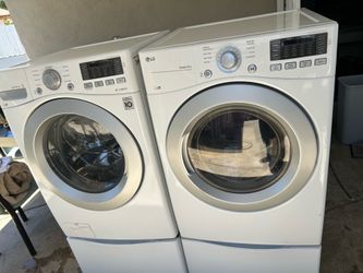 LG front load washer and gas dryer with pedestals