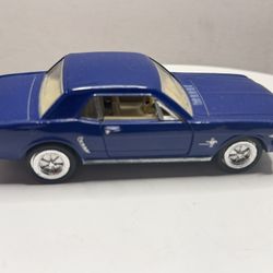 This is a collectible model car: a Kinsmart 1964 1/2 Ford Mustang in 1:36 scale.