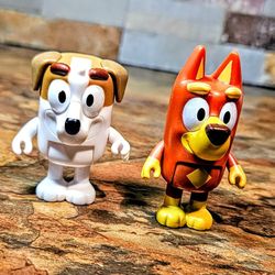 This Is A 2-Lot Of Collectable Action Figures From The Animated Series Bluey • The Figure On The Left Is Rusty A Red Kelpie Dog • 