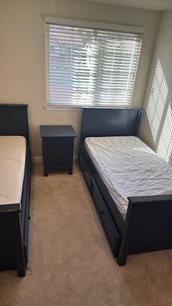Bedroom set with two twin beds, night stand and dresser.