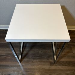 Small White Side Table - The Tabletop is made from engineered wood and plastic with a glossy PVC veneer that reflects the light with a Chrome-finished