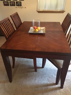 Wooden rectangular table with four chairs and leaf