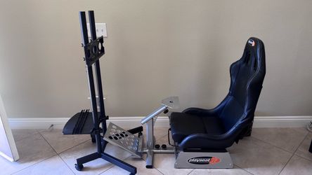 Playseat racing sim cockpit with TV monitor stand