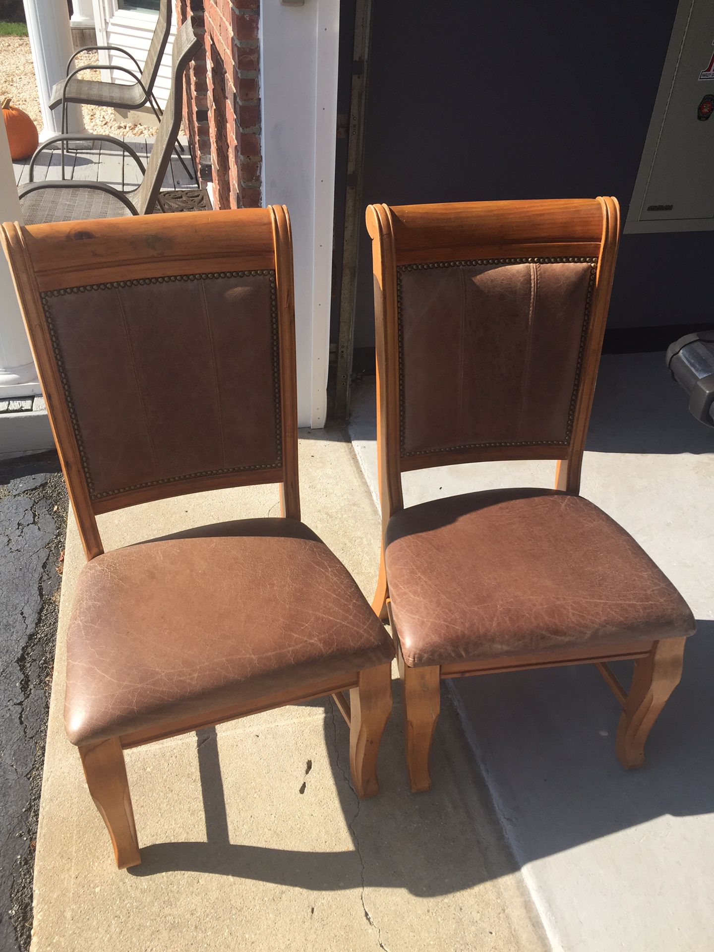2 sturdy wooden and leather chairs