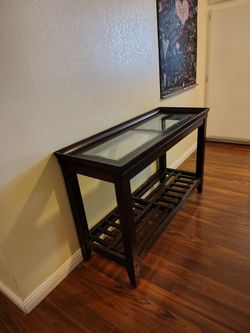 Console table, couch table, sofa table, display table with 2 beveled glass inserts on top
47 3/8" wide x 18 1/4" deep x 30 5/8" tall
Klaussner Furnitu