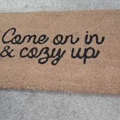 Beige Background & "Come On In & Cozy Up" Written In Black Script Outdoor Doormat