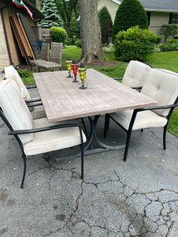 Patio table and 4 iron chairs with cushions and umbrella stand