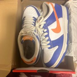 Varsity Jacket And Nike Dunk Low GS in the Blue Joy/Mandarin-White colorway.
