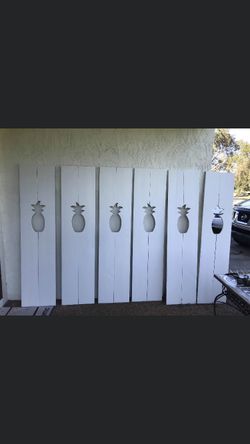 Solid wood exterior window shutters with pineapple cut outs