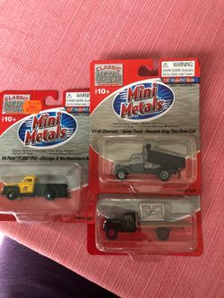 Three mini metals trucks