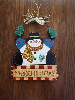 Painted wood hanging holiday decor.