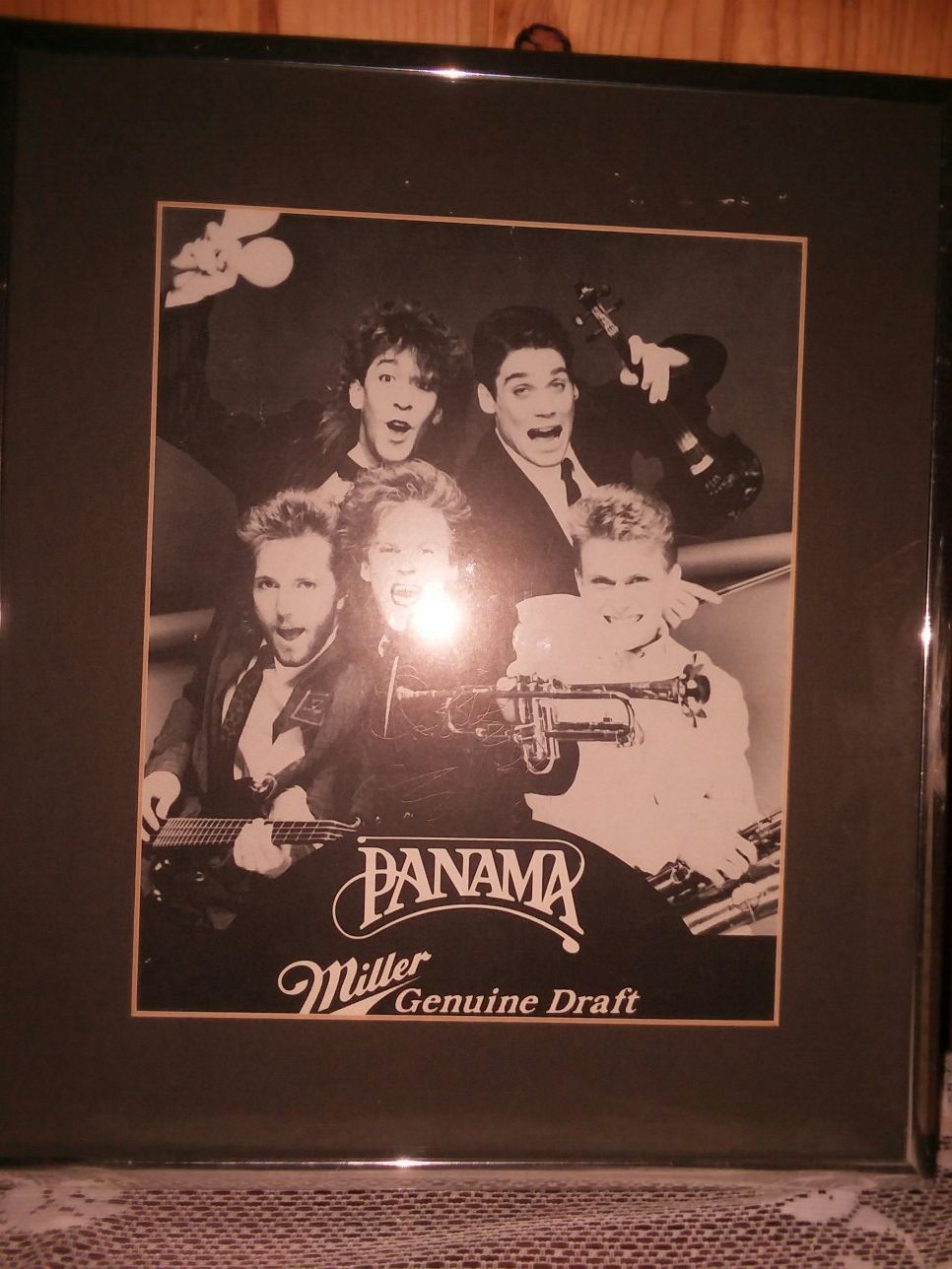 Sign picture 5 Miller beer I don't know who the group is the signature is etched in the picture you have to turn it so you can see it