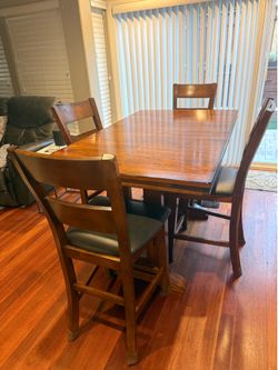 Bar height table with extensions and 4 chairs