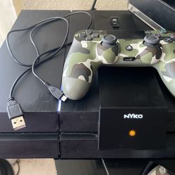 PlayStation 4 Console, A DualShock 4 Controller, And A Nyko Charging Base.   PRICE IS FIRM