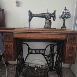 Antique Singer sewing machine in cabinet