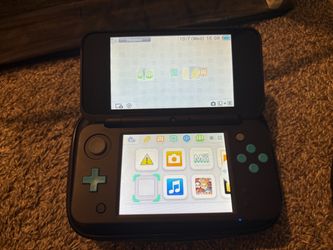 Nintendo 2DS XL with game lot.