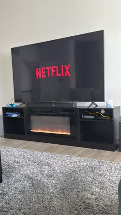 LG 75”Flat Screen TV + sound bar w/ Stand and Fireplace