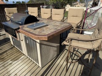 Built In Traeger Bbq With Island And Metal Chairs