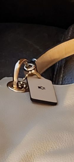 Coach purse with dust cover, bag charm and monogrammed paw print