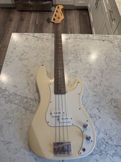 Selling a Mahar 4-string electric bass guitar in a classic cream/ivory finish.