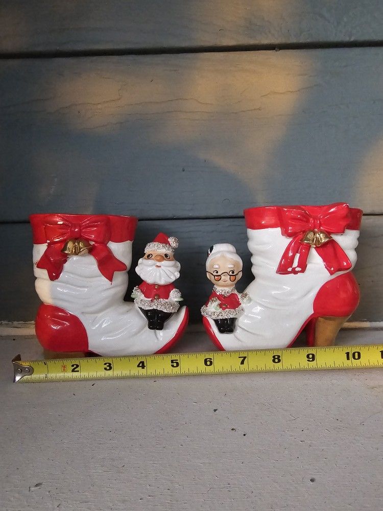Santa and Mrs Claus Sitting on the Toe of Bow and Bell Trimmed Christmas Boot