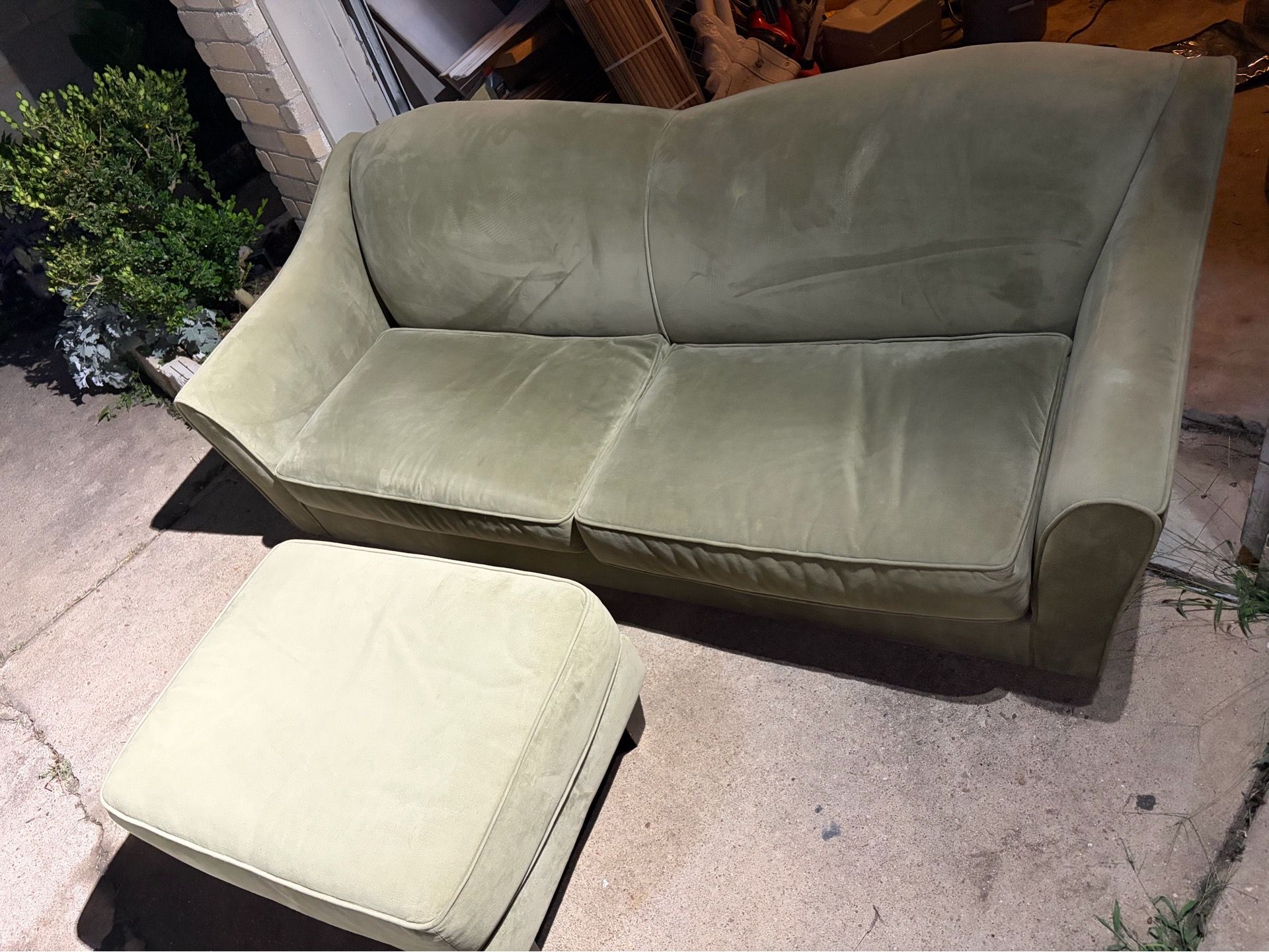 Green suede sofa with feet rest