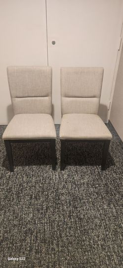 beige and black upholstered dining chairs
