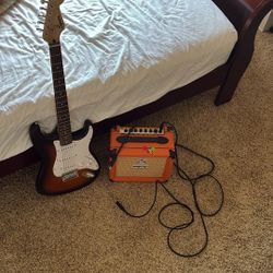 Squire stratocaster guitar with orange amp 