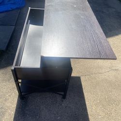 lift top coffee table with an espresso finish, wheels, and a hidden storage compartment.