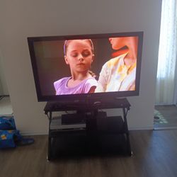 55 In LG TV And Smoke Glass TV Stand