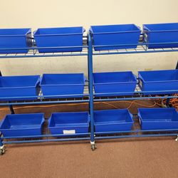 Rolling metal rack with locking wheels and 12 storage bins