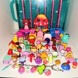 lot of 60+ Shopkins figures, display case, and charm bracelot