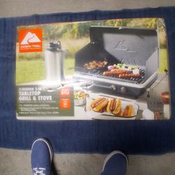 NEW IN SEALED BOX, STATE OF THE ART COOKING UTENSIL, "OZARK TRAIL" DUAL BURNER 20,000 BTU'S, TABLE TO STOVE AND GRILL, 60 SQ INCH POT SPACE AND 122 SQ